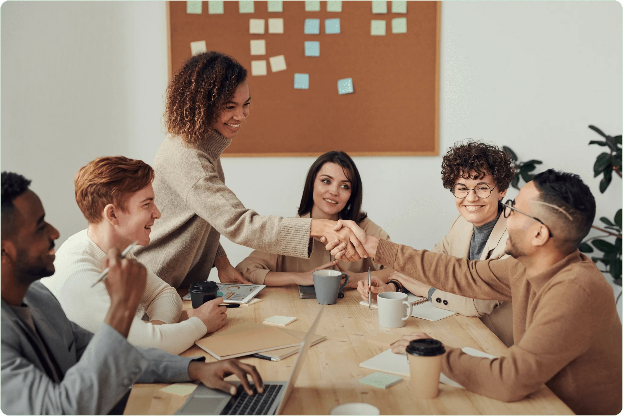 Startup team brainstorming in modern bright office with analytics on screen